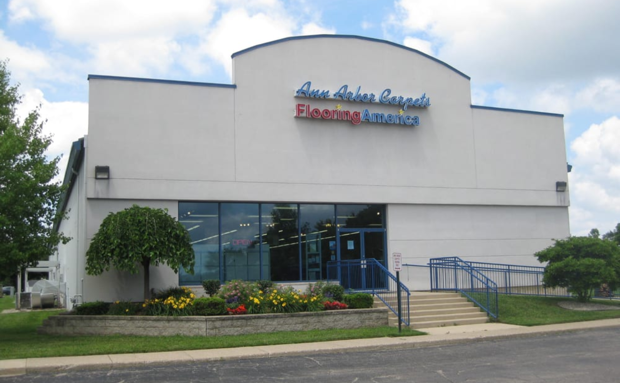Father and son playing on the hardwood flooring.