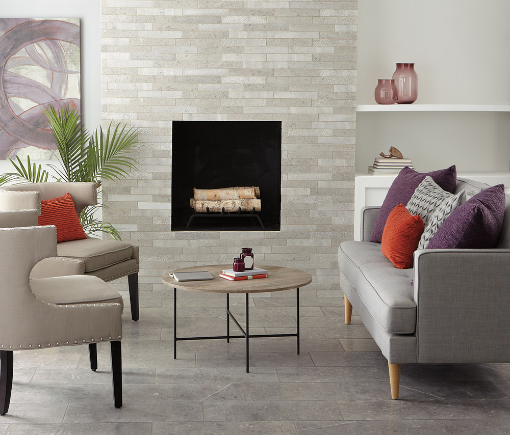 Tile flooring in living room surrounded by chairs and a fireplace